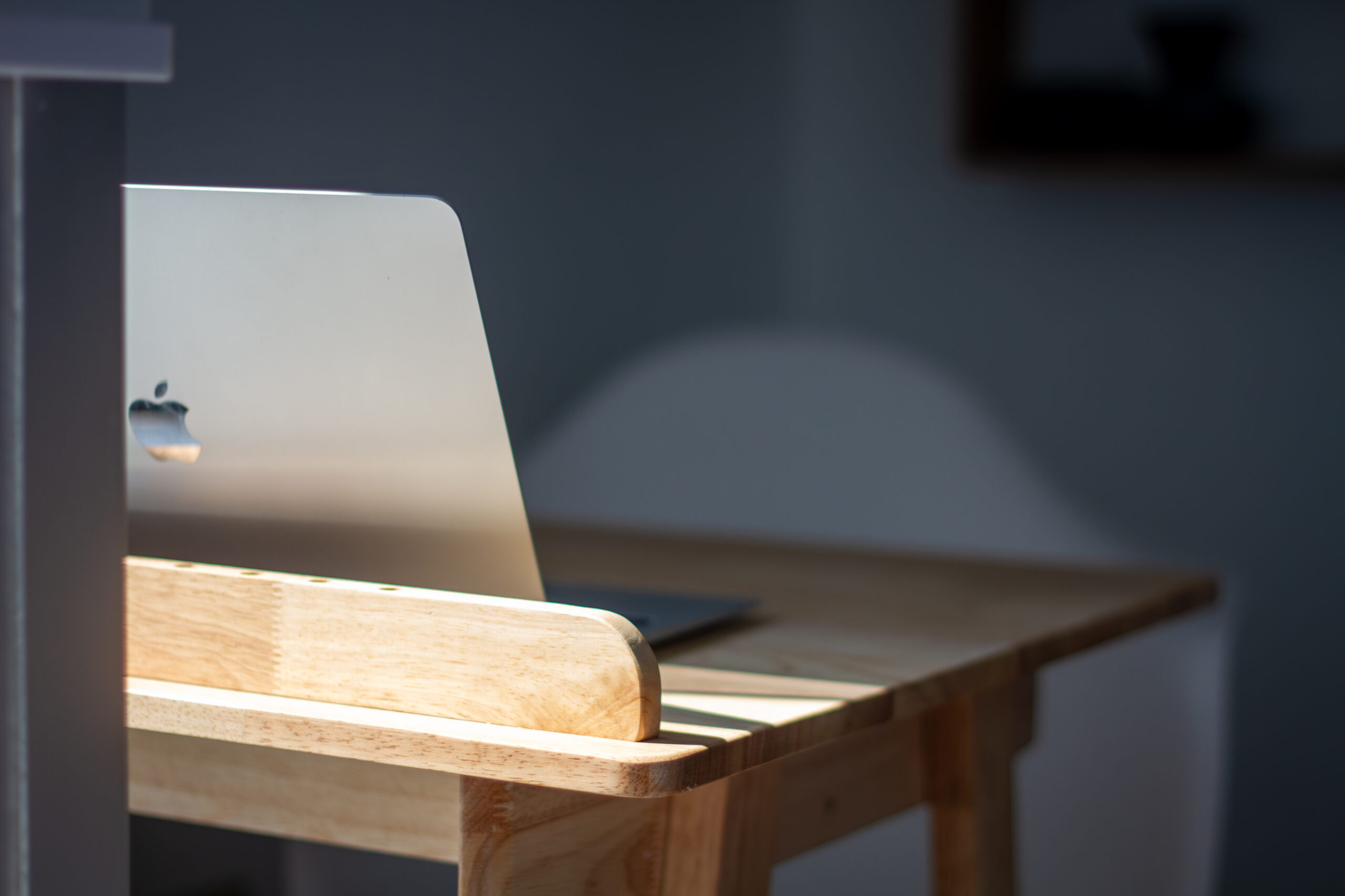 A well-lit therapist's office with a laptop on a desk used during Dr. Christopher Miller's therapy sessions.
